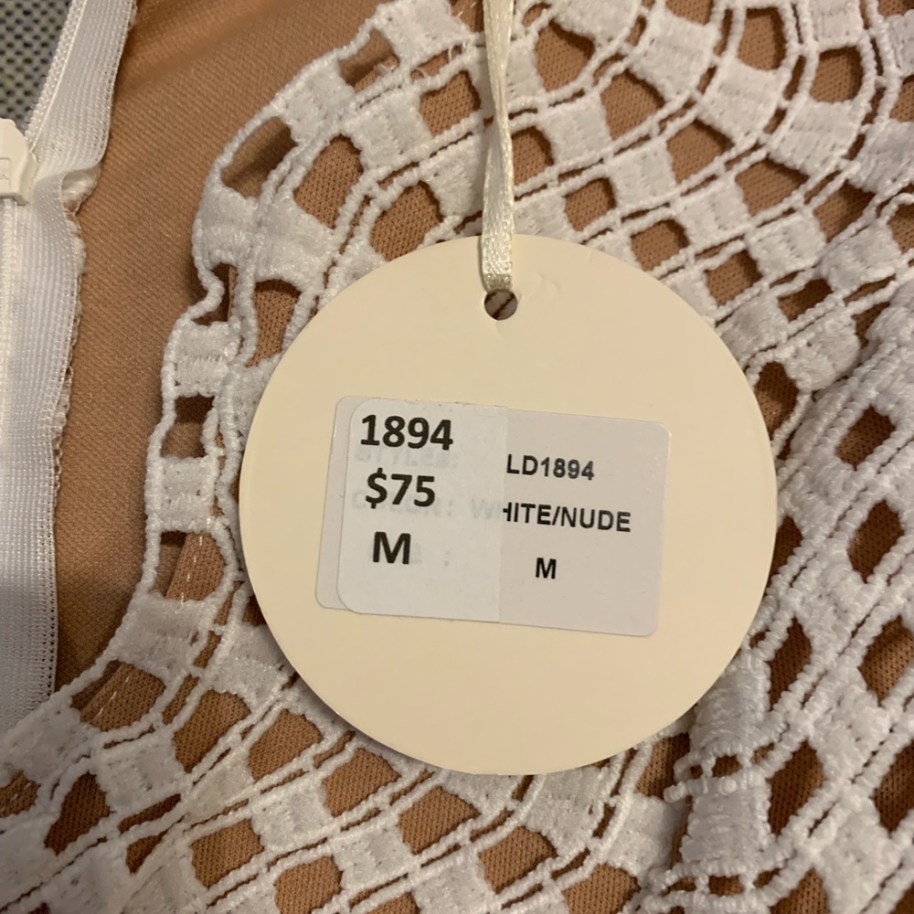 Beautiful white dress with tan lining.